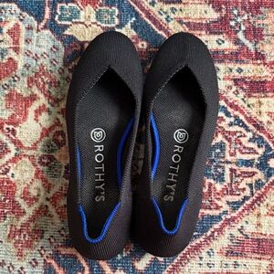 Rothy's Elegant Black Flats with Vibrant Blue Accent